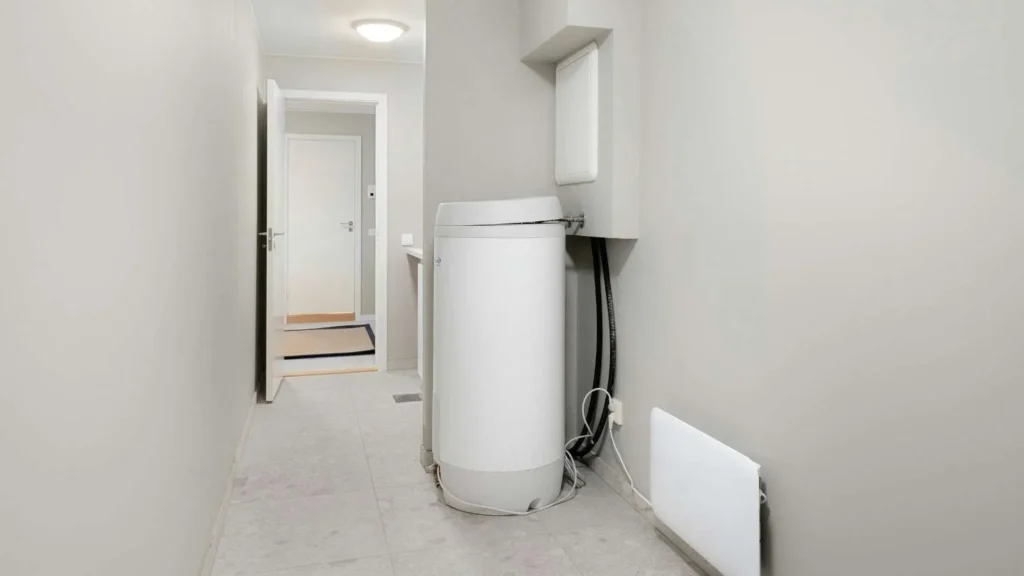 Electric water heater tank in a laundry room for home maintenance