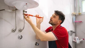 plumber inspecting water heater for rumbling noise