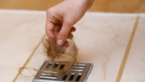 Hair clog being removed from sink drain