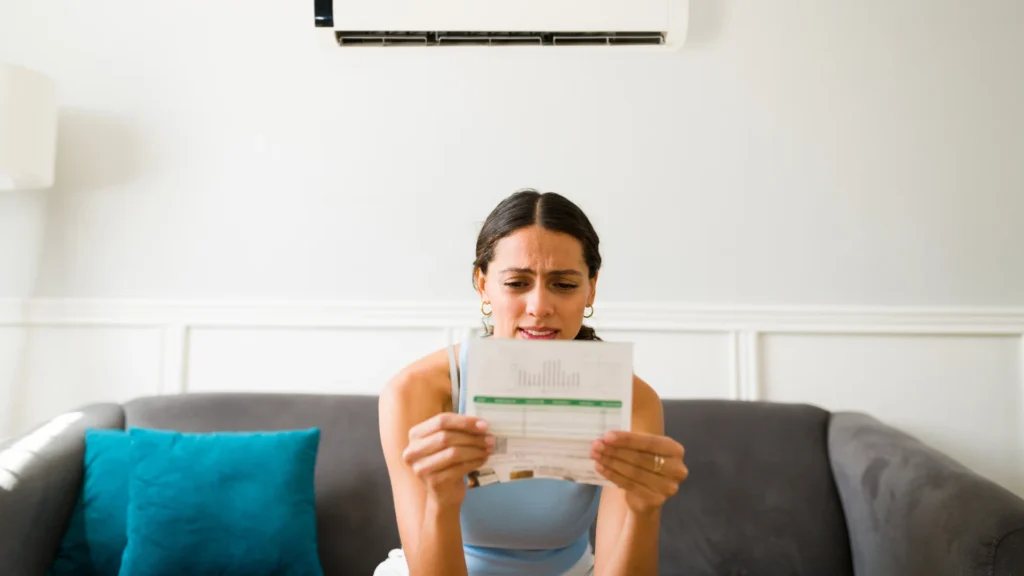 Homeowner holding a water bill showing a sudden increase in charges