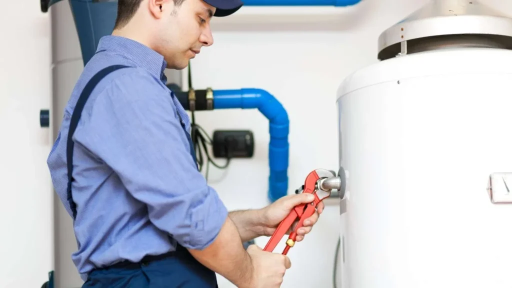 Plumber inspecting and repairing a residential water heater